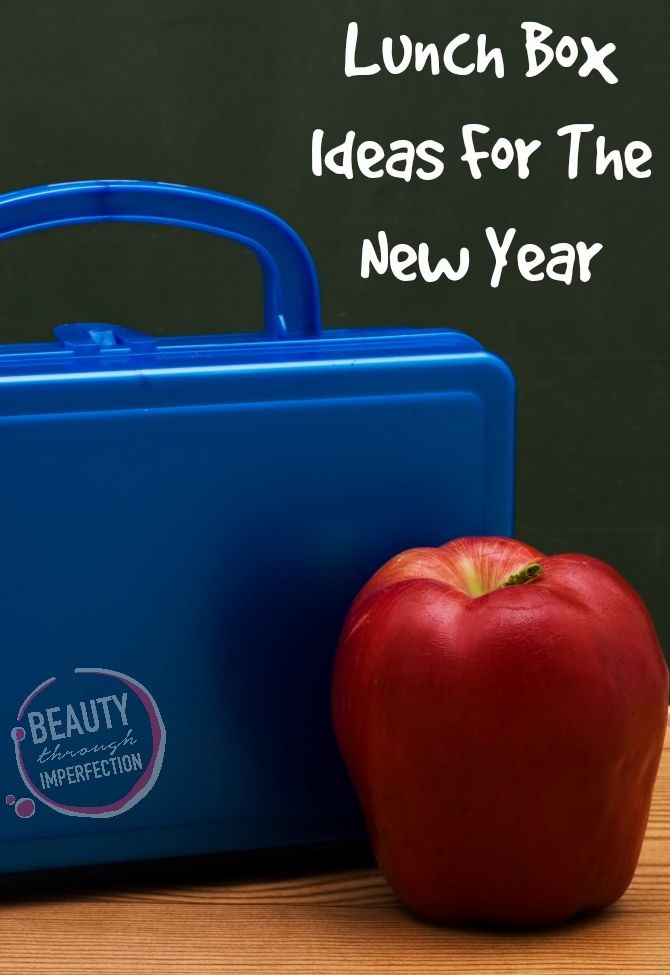 A blue lunchbox with an apple in front of a chalkboard, School Lunches